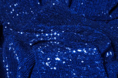  ile mavi kumaş. Göz alıcı bir ilişki için bu mavi maske spor. Dairesel çocuk sparkles yoğun bir düzenleme tüm kaplama için düz örgü gücü kapsamında kalır