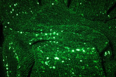 Doku, arka plan, desen, ile yeşil kumaş. Payetler payetler bu kumaş üzerine her açıdan göz kapmak üst üste gelen düz çizgiler içine dikilir ile bir açıklama yapmak.