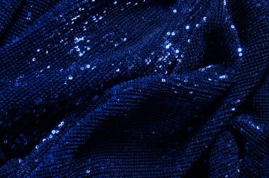  ile mavi kumaş. Göz alıcı bir ilişki için bu mavi maske spor. Dairesel çocuk sparkles yoğun bir düzenleme tüm kaplama için düz örgü gücü kapsamında kalır