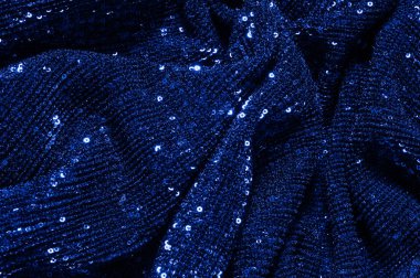  ile mavi kumaş. Göz alıcı bir ilişki için bu mavi maske spor. Dairesel çocuk sparkles yoğun bir düzenleme tüm kaplama için düz örgü gücü kapsamında kalır