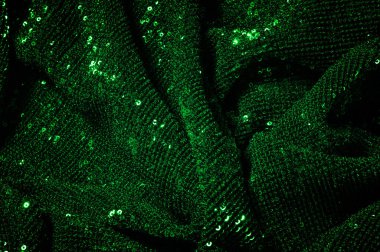 Doku, arka plan, desen, ile yeşil kumaş. Payetler payetler bu kumaş üzerine her açıdan göz kapmak üst üste gelen düz çizgiler içine dikilir ile bir açıklama yapmak.