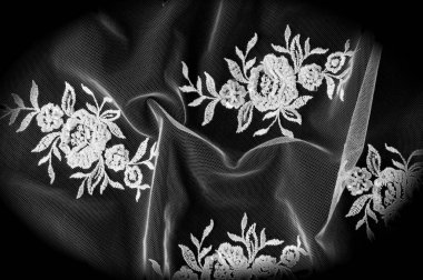 Doku, arka plan, desen. Dantelli beyaz kumaş. Çiçek dantel kumaştan yapılmış. İzole siyah arka plan. tebrik kartı. Masaüstü duvar kağıdı. Tasarımcı için ekran koruyucu zemin