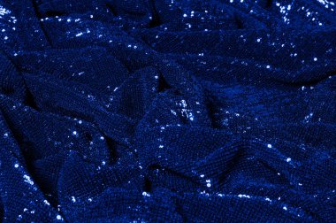  ile mavi kumaş. Göz alıcı bir ilişki için bu mavi maske spor. Dairesel çocuk sparkles yoğun bir düzenleme tüm kaplama için düz örgü gücü kapsamında kalır