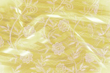 Doku, arka plan, desen. Sarı bez kumaş kumaş kumaş arka plan üzerinde. Sarı Pembe dantel çiçek kumaş close-up. Sarı dantelli çiçek kumaş Close-Up