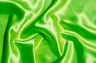 Doku, kumaş, arka plan. Lüks kumaş ya da sıvı dalgalar ya da dalgalı kırışık ipek saten doku kadife malzeme ya da lüks Noel ya da zarif arka plan arka plan. Yeşil