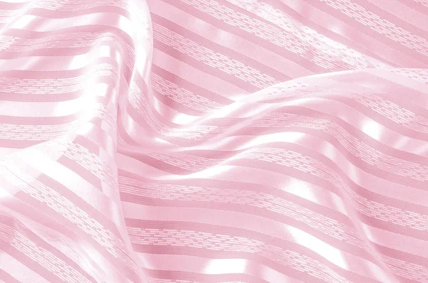 Arka plan doku, desen. Hafif bir şerit ile pembe ipek kumaş. Bir pürüzsüz zarif pembe ipek ya da saten doku arka plan olarak kullanılabilir. Renk rose kuvars pembe pastel tonlu eğilimini