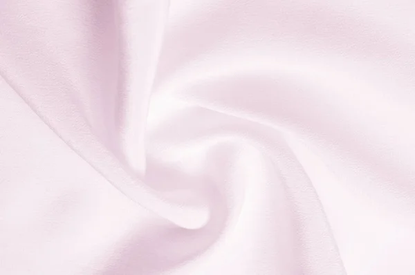 Texture background pattern. Pink silk fabric. Closeup of a rippled pink silk fabric. Advertising space. Smooth elegant pink silk can be used as a wedding background.