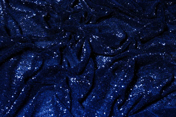  ile mavi kumaş. Göz alıcı bir ilişki için bu mavi maske spor. Dairesel çocuk sparkles yoğun bir düzenleme tüm kaplama için düz örgü gücü kapsamında kalır