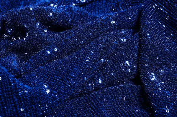  ile mavi kumaş. Göz alıcı bir ilişki için bu mavi maske spor. Dairesel çocuk sparkles yoğun bir düzenleme tüm kaplama için düz örgü gücü kapsamında kalır