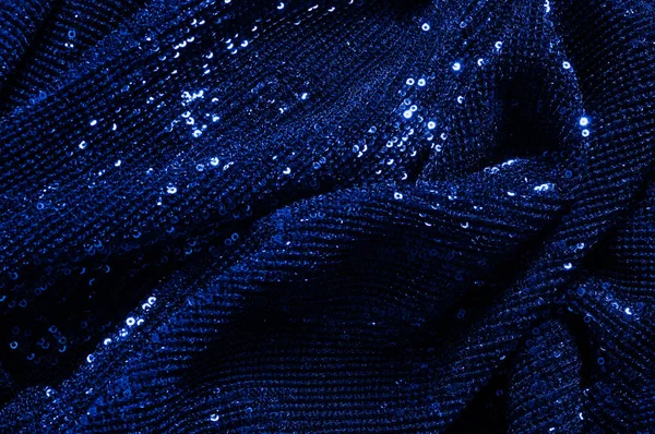  ile mavi kumaş. Göz alıcı bir ilişki için bu mavi maske spor. Dairesel çocuk sparkles yoğun bir düzenleme tüm kaplama için düz örgü gücü kapsamında kalır