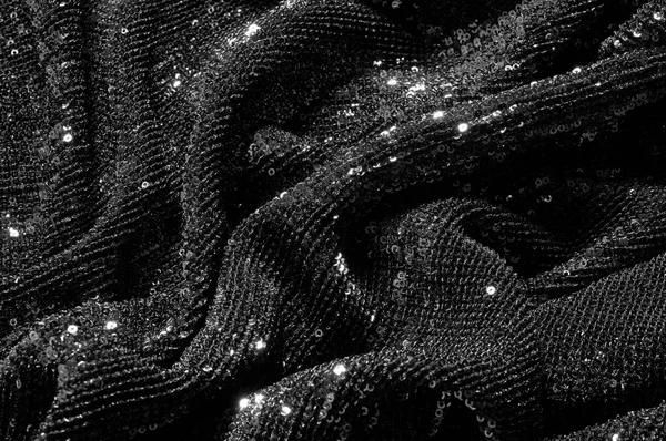 Black fabric with paillettes Make a dazzling debut  this Black Baby Sequined  The coating of the strength of the continuous mesh remains a dense arrangement of circular glitters for the entire coating