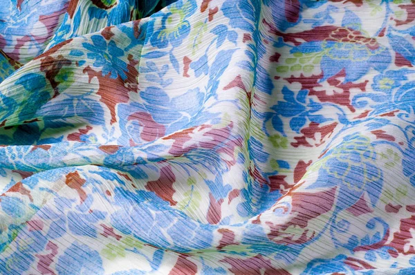 Doku, arka plan, desen. Kumaş krep de chine. Mavi beyaz pişmiş toprak yeşil. Kumaş üzerine boyalı çiçekler vardır. Soyut çizim