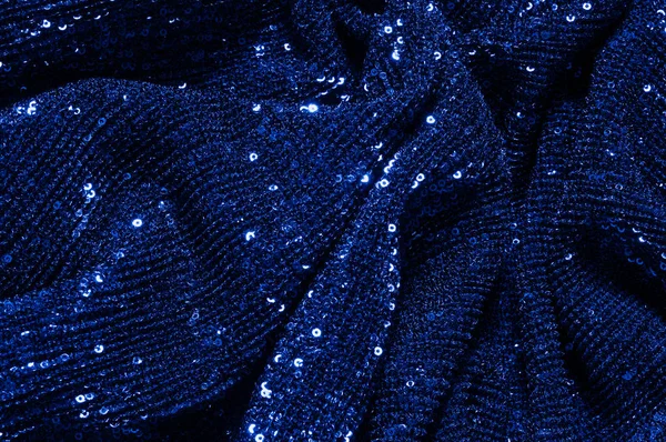  ile mavi kumaş. Göz alıcı bir ilişki için bu mavi maske spor. Dairesel çocuk sparkles yoğun bir düzenleme tüm kaplama için düz örgü gücü kapsamında kalır