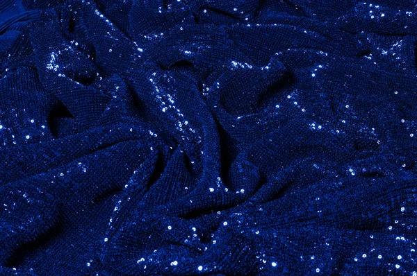  ile mavi kumaş. Göz alıcı bir ilişki için bu mavi maske spor. Dairesel çocuk sparkles yoğun bir düzenleme tüm kaplama için düz örgü gücü kapsamında kalır