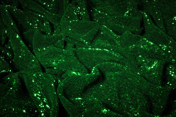 Texture, background, pattern, green fabric with paillettes. Make a statement with sequins Sequins on this fabric are sewn into overlapping straight lines that grab your eye from any angle.