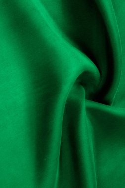 Arka plan doku, desen. Kalın kalın ipek kumaş yeşildir. Bu saten kumaş tasarımında bir pürüzsüz akışı oluşturmak için idealdir, bir sıvı örtüsü ve zarif Parlatıcı.