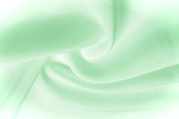 Texture background pattern. Green silk fabric. Closeup of a corrugated green silk fabric. Advertising space. Smooth elegant green silk can be used as a wedding background.