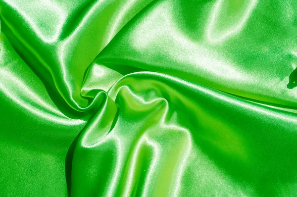 Doku, kumaş, arka plan. Lüks kumaş ya da sıvı dalgalar ya da dalgalı kırışık ipek saten doku kadife malzeme ya da lüks Noel ya da zarif arka plan arka plan. Yeşil