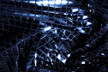 doku, arka plan, desen. Kumaş ile mavi renk büyük parıldıyor. Bu tek tük parıldıyor ile bazı tarzı göstermek! Polyester örgü yüzey üzerinde dağınık, mavi ve beyaz pullu vardır,