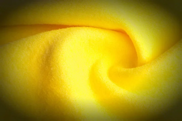 Texture background pattern. Woolen yellow fabric, cloth for a blanket, outer clothing.  Closeup horizontal fragment