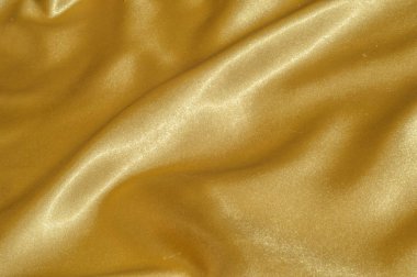 Doku, kumaş, arka plan. Lüks kumaş ya da sıvı dalgalar ya da dalgalı kırışık ipek saten doku kadife malzeme ya da lüks Noel ya da zarif arka plan arka plan. Altın