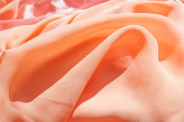 Doku, arka plan, desen. Açık turuncu renkli, ipek topu cüppe elbise. Kumaş mercan ipek