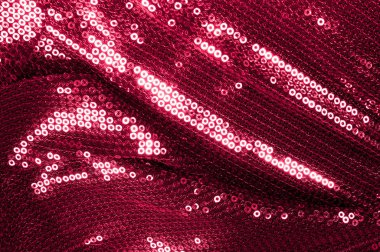 Arka plan doku, desen. İle kumaş kırmızı bordo. Bu Neon pembe birleşiyor payetler bak. Yuvarlak neon pembe birleşiyor payetler yanardöner bir sheen ile şeffaf mor bir kafes arasında örtüşüyor.