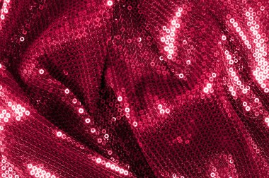 Arka plan doku, desen. İle kumaş kırmızı bordo. Bu Neon pembe birleşiyor payetler bak. Yuvarlak neon pembe birleşiyor payetler yanardöner bir sheen ile şeffaf mor bir kafes arasında örtüşüyor.