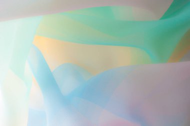 Bulanık, değil keskin netlik doku, arka plan, desen. İpek kumaş şeffaf, sarı-pembe yeşil mavi olduğunu. Soyut yumuşak şifon doku arka plan. 