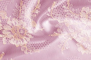 Resmi doku arka planı, dekoratif altın dantel desenli. Altın vintage dantelli arka plan. Altın dantel pembe bir arka plan üzerinde. Spandex, makro. Dantelli dekoratif çiçek desenli.