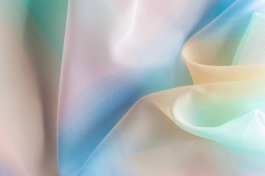 Doku, arka plan, desen. İpek kumaş şeffaf, sarı-pembe yeşil mavi olduğunu. Soyut yumuşak şifon doku arka plan. 