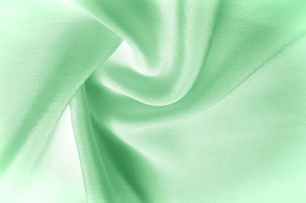 Doku arka plan deseni. Yeşil ipek kumaş. Closeup oluklu yeşil ipek kumaş. Reklam alanı. Pürüzsüz zarif yeşil ipek düğün arka plan olarak kullanılabilir.