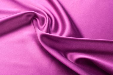 Doku arka planını kumaş. Kırmızı ipek kumaş. Koyu kırmızı sahne perdesi bir parçası. Lüks kumaşlar ya da sıvı dalgalar ya da dalgalı ipek saten doku kadife malzeme veya lüks kıvrımları arka plan