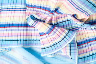 Pileli kumaş. Sinii sarı kırmızı beyaz çizgili doku. Fotoğraf stüdyosu