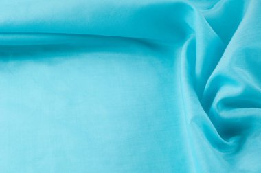 Doku arka planını kumaş. Mavi kumaş, aqua, mavi, Bondi mavi, gök mavisi, mavi mavi, pembe yumurta mavi, Skobelov, Turkuaz, çiçek adları ipek. İpek veya saten yumuşak zarif mavi bir arka plan olarak kullanılabilir