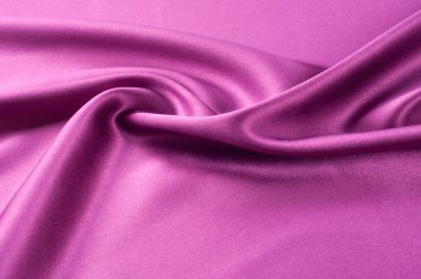 Doku arka planını kumaş. Kırmızı ipek kumaş. Koyu kırmızı sahne perdesi bir parçası. Lüks kumaşlar ya da sıvı dalgalar ya da dalgalı ipek saten doku kadife malzeme veya lüks kıvrımları arka plan