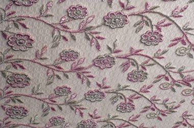 Doku, arka plan, desen. Pembe dantel çiçek üzerinde beyaz bir arka plan ile dekore edilmiştir. Arka planını çiçekler ile dekore edilmiş pembe dantel kumaş