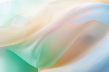 Doku, arka plan, desen. İpek kumaş şeffaf, sarı-pembe yeşil mavi olduğunu. Soyut yumuşak şifon doku arka plan. 