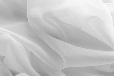 Doku, arka plan, desen. İpek kumaş şeffaf, beyaz renkte. Soyut yumuşak şifon doku arka plan. Eğri ve dalga ile yumuşak beyaz şifon