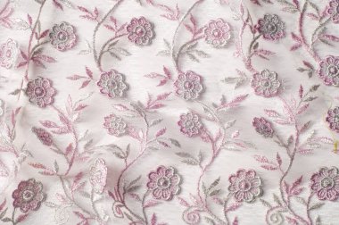 Doku, arka plan, desen. Pembe dantel çiçek üzerinde beyaz bir arka plan ile dekore edilmiştir. Arka planını çiçekler ile dekore edilmiş pembe dantel kumaş