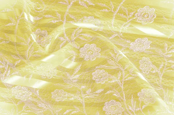 Doku, arka plan, desen. Sarı bez kumaş kumaş kumaş arka plan üzerinde. Sarı Pembe dantel çiçek kumaş close-up. Sarı dantelli çiçek kumaş Close-Up