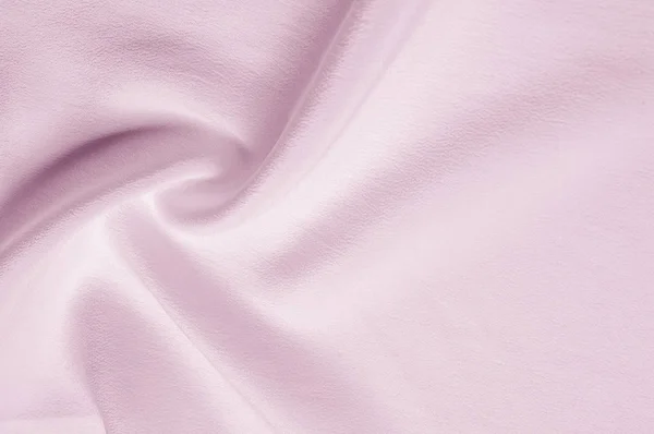 Texture background pattern. Pink silk fabric. Closeup of a rippled pink silk fabric. Advertising space. Smooth elegant pink silk can be used as a wedding background.