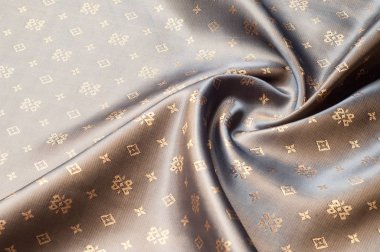 Doku arka plan deseni. Kahverengi ipek kumaş. Arka plan lüks kumaşlar ya da sıvı dalgalar ya da dalgalı kırışıklıklar. Pürüzsüz zarif altın ipek ya da içinde saten sepya tonlu. Retro tarzı