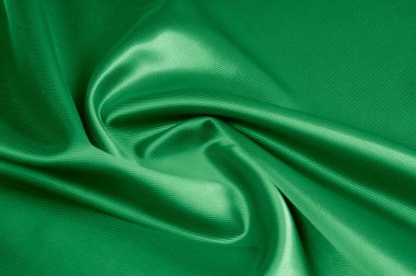Doku, arka plan, desen. Yeşil ipek kumaş dokusu. Güzel zümrüt yeşil yumuşak ipek kumaş.