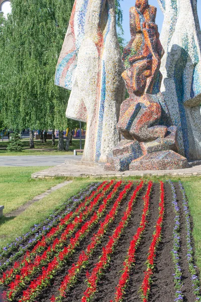 Summer landscape, city flower beds with flowers. Blossoming colorful flowerbeds in summer city park.