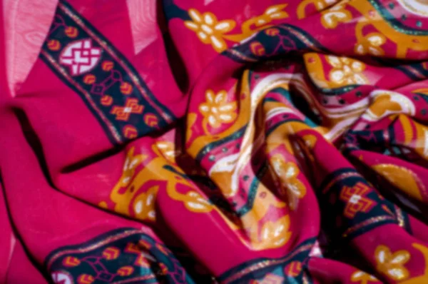 blurry. Background texture, pattern. Red maroon fabric. Click on your local heritage with this red, bard and yellow striped silk. This patterned fabric will decorate your design.