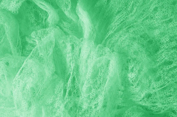 Cloth in a mesh green. Add a line of ethereal brilliance to your — Stock Photo, Image