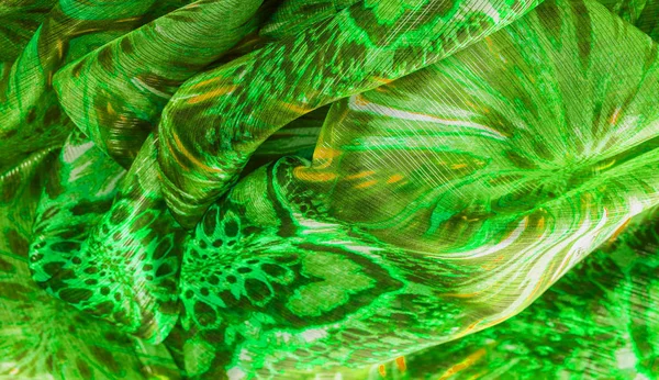 Background texture, pattern. Silk from a greenish emerald shade.