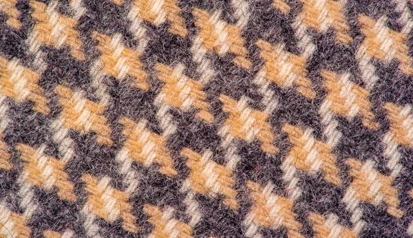 Background texture, pattern. The fabric is thick, warm in a cage Royalty Free Stock Images