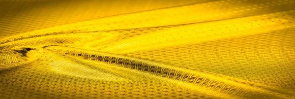 Background texture, pattern. Yellow, mustard silk fabric with a — Stock Photo, Image